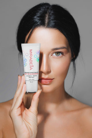 Mirabella model holding the new Hydrate, Prime, & Protect SPF 30 Makeup Primer