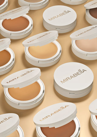 Close-up of Mirabella Beauty Pure Press Powder Foundation in various shades, showcasing smooth, finely milled texture for flawless coverage.