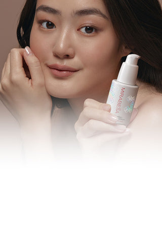 Mobile banner image of Mirabella skincare model holding the new All-In-One Clarifying Serum with AHA/BHAs & Glycolic Acid